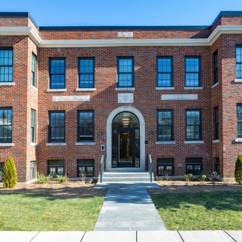 The essence of exceptional living a brick building with a green lawn
