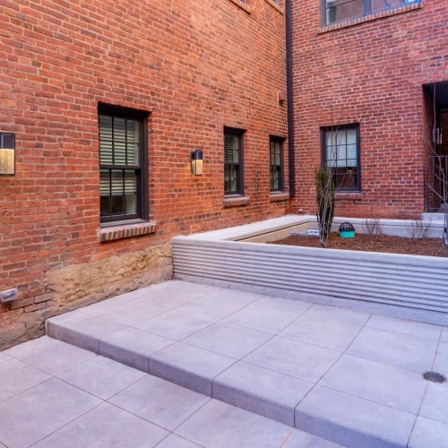 Find your perfect fit at 35th Street Residences a brick building with a stone walkway