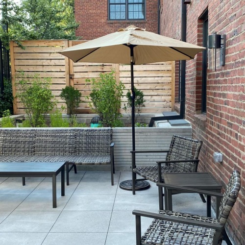 Refined spaces to match your style a patio with a table and chairs